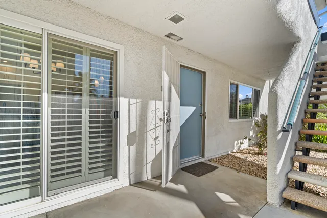 a view of a kitchen with a sink and refrigerator