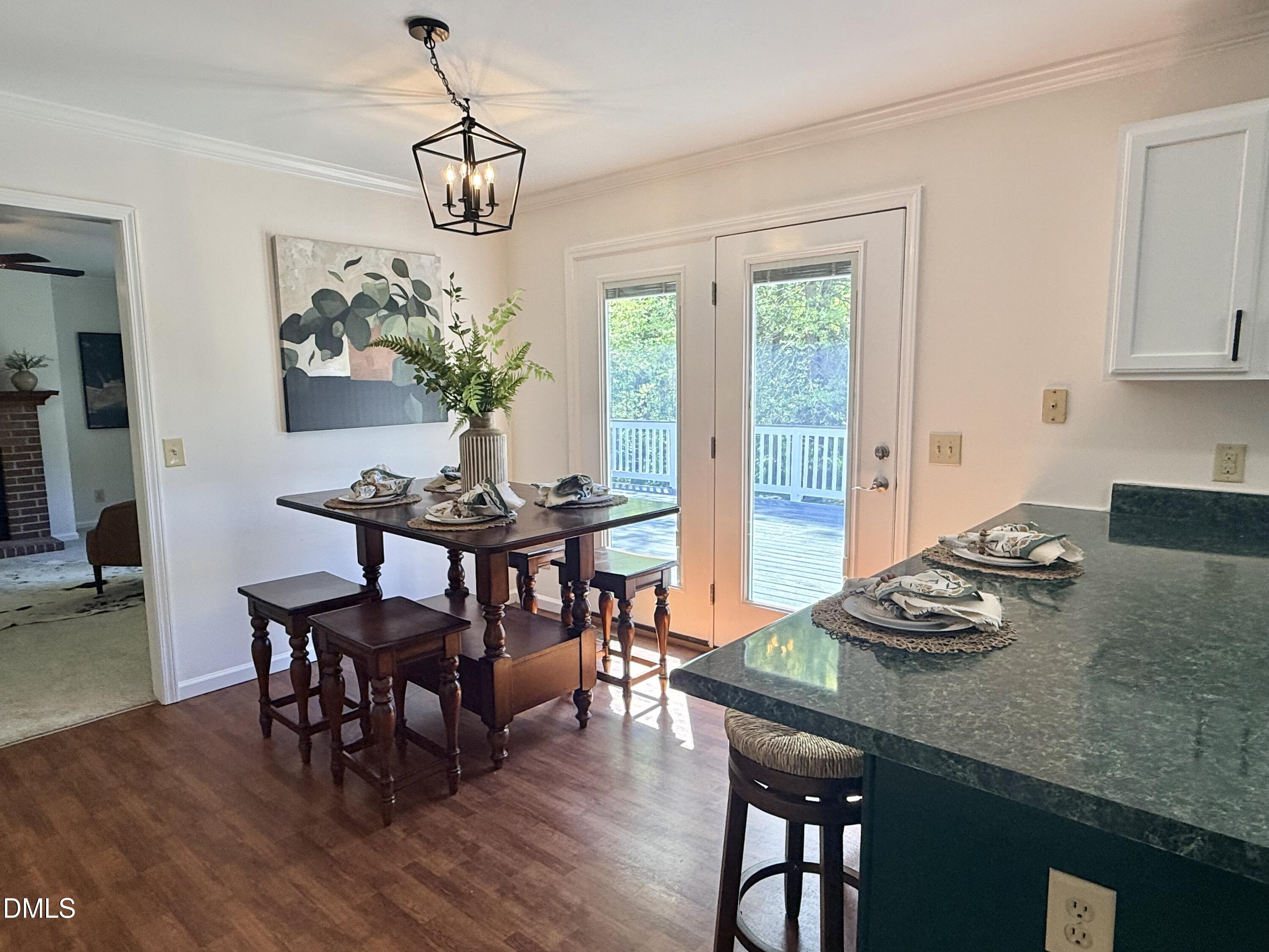 2429 Halifax Road Roxboro, NC 27573 - Photo 14 of 54 a view of a dining room with furniture window and wooden floor