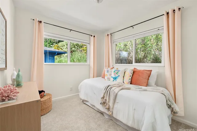 a bed sitting in a bedroom next to a window