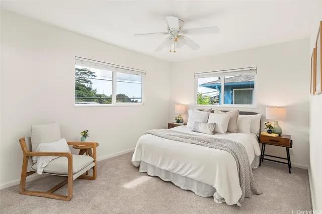 a bedroom with a bed a chair and a window