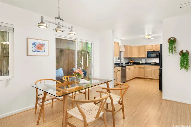 a view of a dining room with furniture and a kitchen