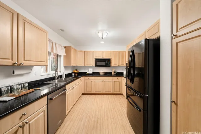 a large kitchen with a large window and stainless steel appliances