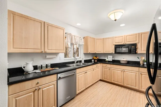 a kitchen with granite countertop white cabinets and white appliances