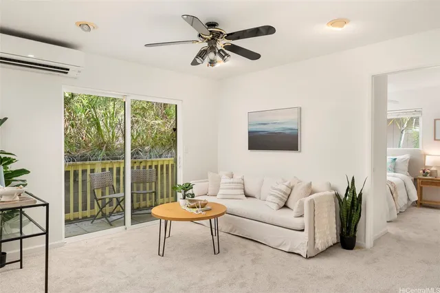 a living room with furniture a table and a large window