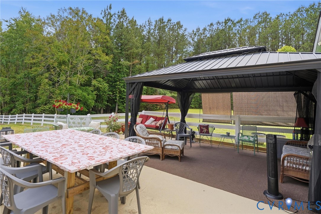 11016 Pridesville Road Amelia Court House, VA 23002 - Photo 44 of 54 an outdoor space with furniture and umbrella