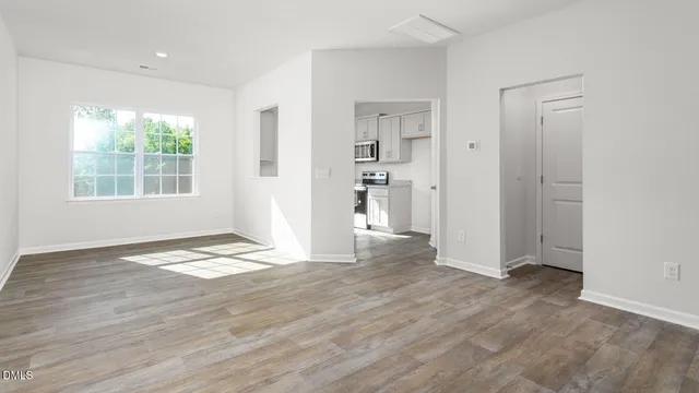 wooden floor in an empty room with a window