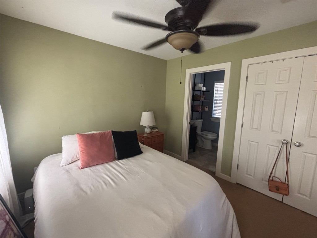 3308 Randolph Road, Unit B Austin, TX 78722 - Photo 11 of 16 a bedroom with a bed and a ceiling fan