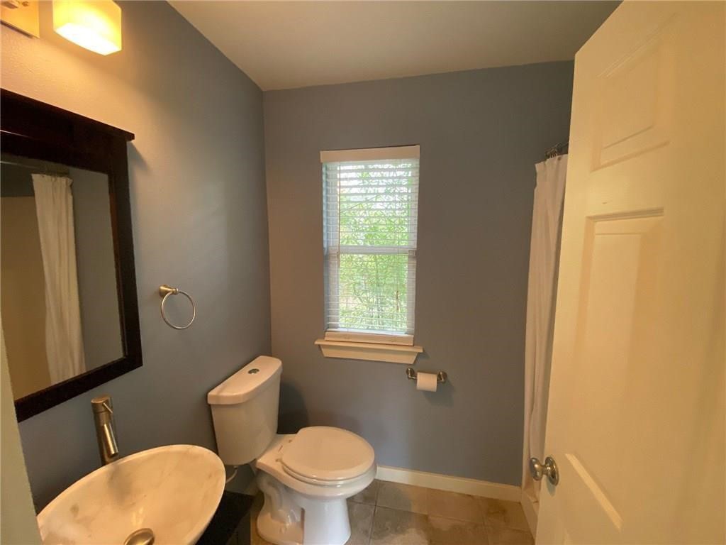 3308 Randolph Road, Unit B Austin, TX 78722 - Photo 14 of 16 a white toilet sitting next to a window