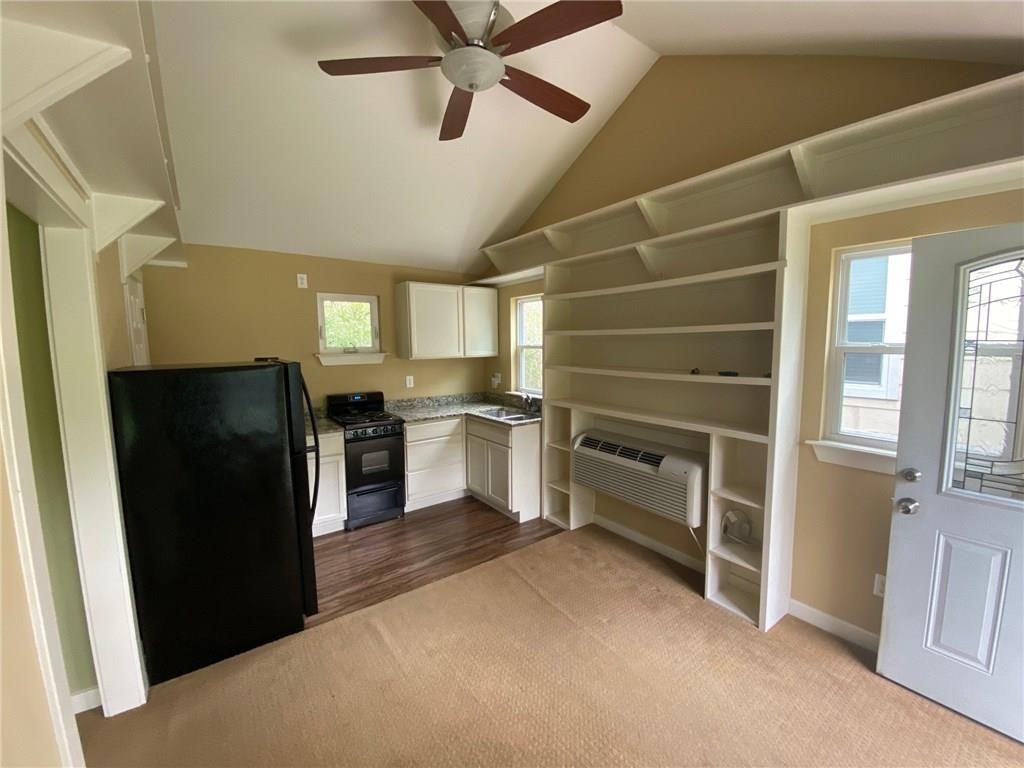 3308 Randolph Road, Unit B Austin, TX 78722 - Photo 3 of 16 a kitchen with a refrigerator and a sink