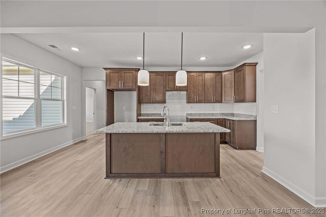 3180 Cameron Hill Road Cameron, NC 28326 - Photo 13 of 46 a large kitchen with stainless steel appliances a large counter top a sink a refrigerator and a stove