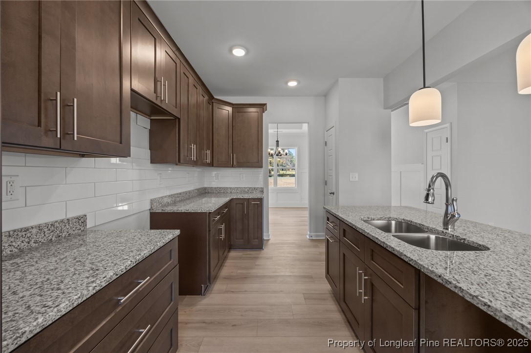 3180 Cameron Hill Road Cameron, NC 28326 - Photo 16 of 46 a kitchen with granite countertop stainless steel appliances a sink stove top oven and cabinets