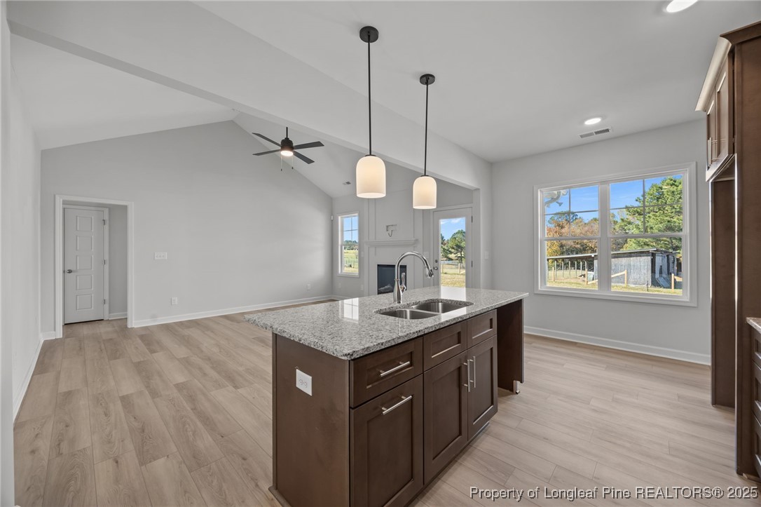 3180 Cameron Hill Road Cameron, NC 28326 - Photo 17 of 46 a kitchen with a stove a sink a window and wooden floor