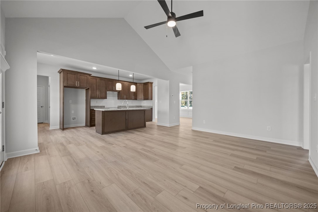 3180 Cameron Hill Road Cameron, NC 28326 - Photo 18 of 46 wooden floor in an empty room with a kitchen