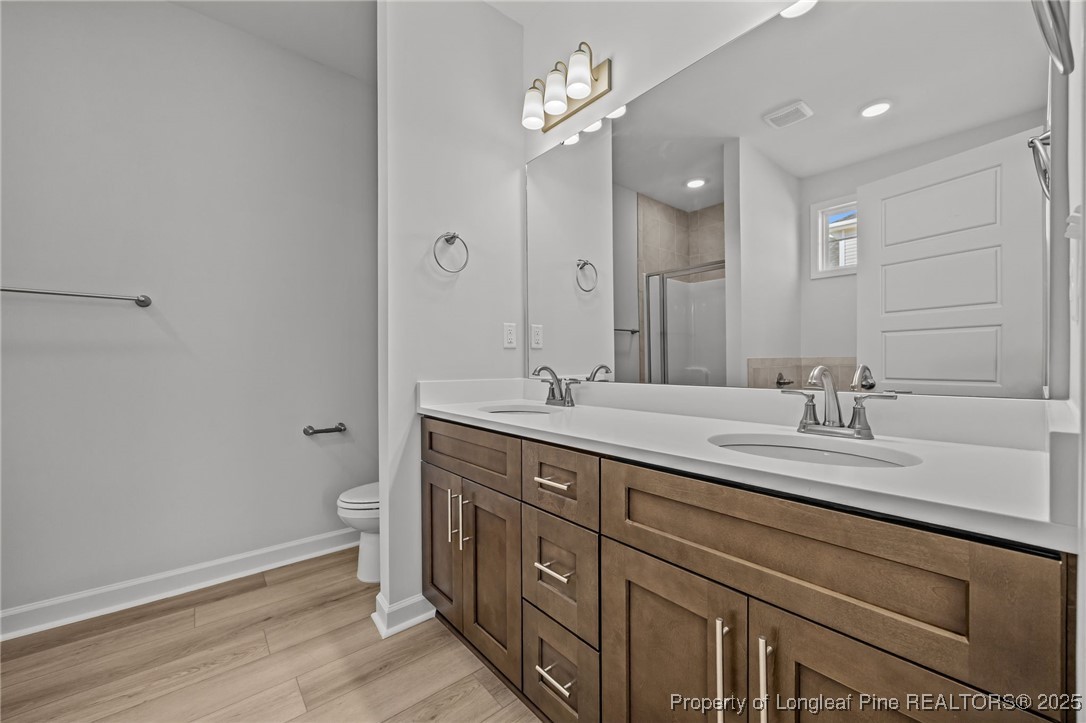 3180 Cameron Hill Road Cameron, NC 28326 - Photo 25 of 46 a spacious bathroom with a granite countertop sink a toilet and a mirror