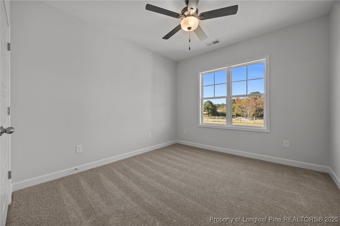 3180 Cameron Hill Road Cameron, NC 28326 - Photo 28 of 46 an empty room with a window and ceiling fan