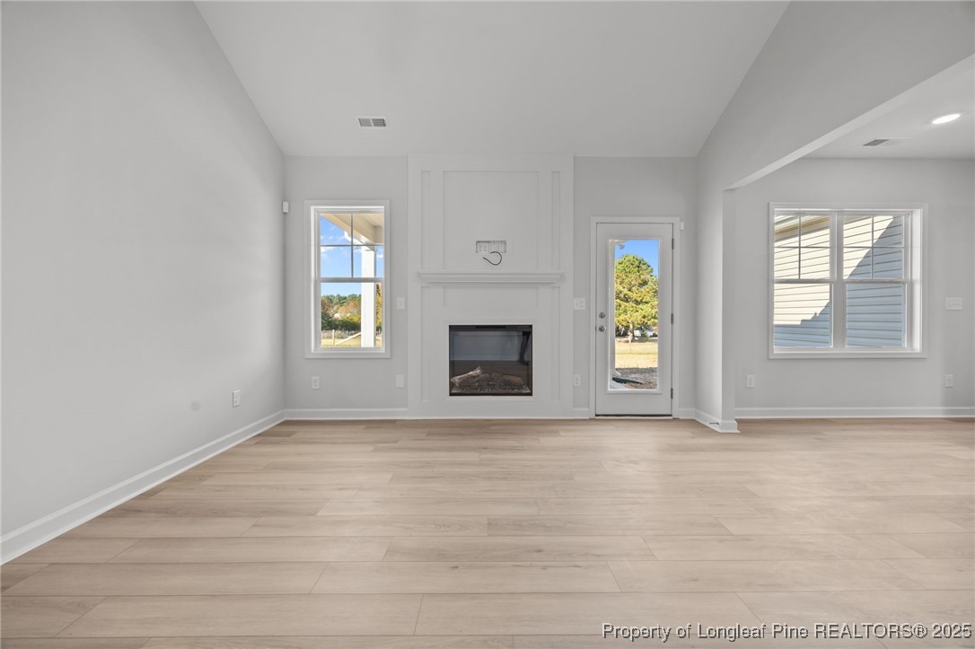 3180 Cameron Hill Road Cameron, NC 28326 - Photo 7 of 46 wooden floor fireplace and windows in an empty room
