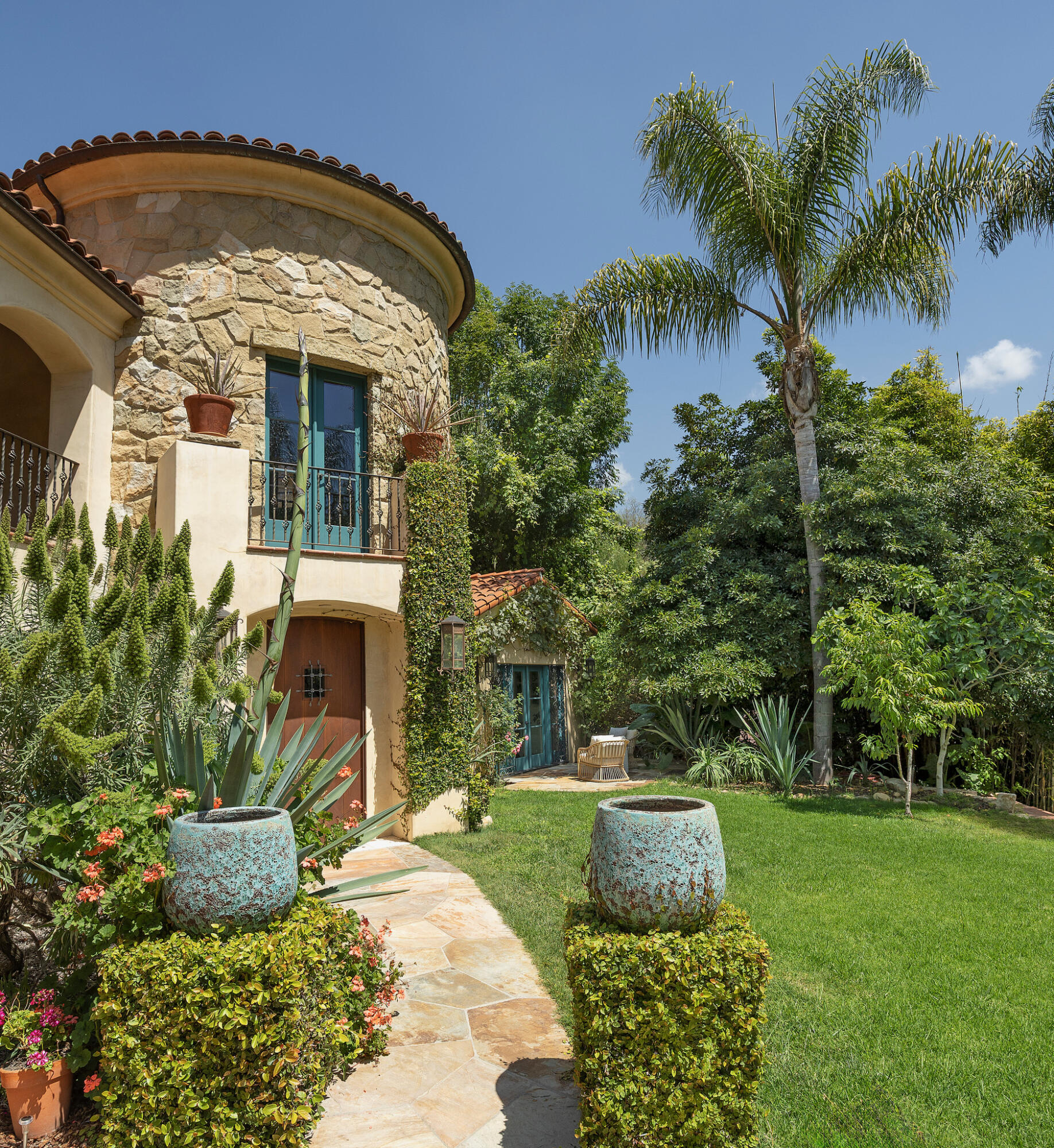 1493 Sycamore Canyon Road Montecito, CA 93108 - Photo 4 of 47 a front view of a house with a garden