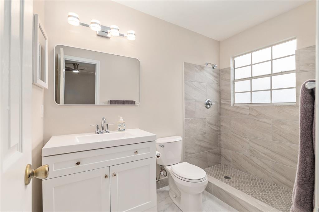 9755 Southwest 52nd Road Gainesville, FL 32608 - Photo 28 of 43 a bathroom with a sink a toilet and shower