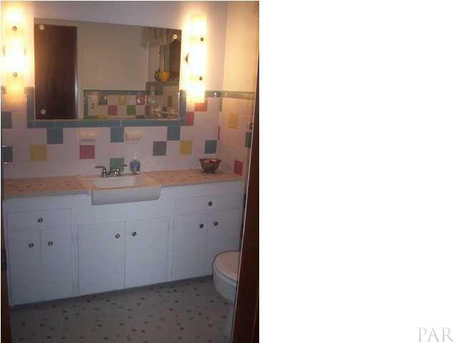 1841 Semur Road Pensacola, FL 32503 - Photo 14 of 23 Split level main bath with super sunken tile shower-room! Dig the mad tiles man! These babies are IN again.