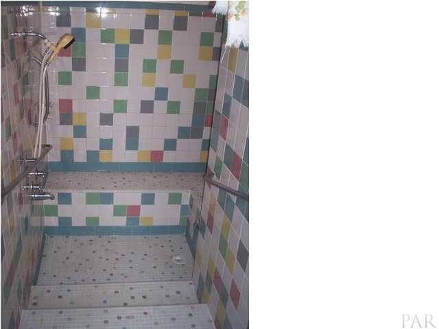 1841 Semur Road Pensacola, FL 32503 - Photo 15 of 23 VINTAGE ALERT! Sunken shower room, baby! WOW! 4 steps down with wrap-a-round tiled bench. Very expensive to replicate today and I guarantee that your friends don't have one! Would be easy to add additional shower heads to back wall and left wall.