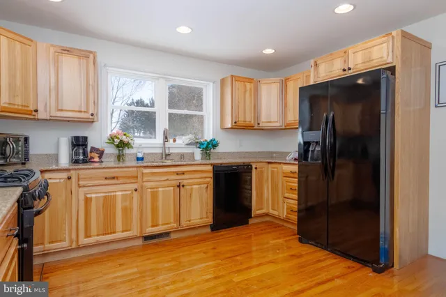 a kitchen with stainless steel appliances granite countertop a refrigerator sink and cabinets