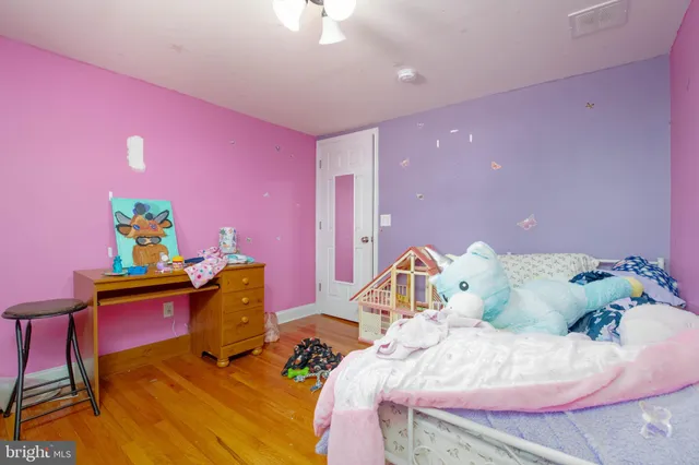 a bedroom with a bed and a desk