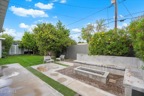 a view of a house with a yard and sitting area