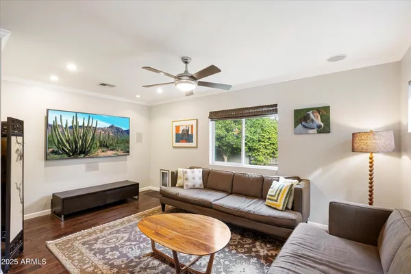 a living room with furniture and wooden floor