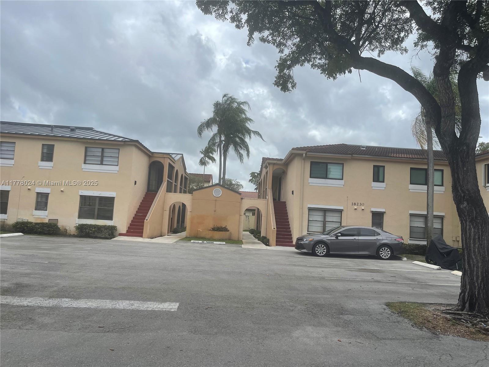 a car parked in front of white house