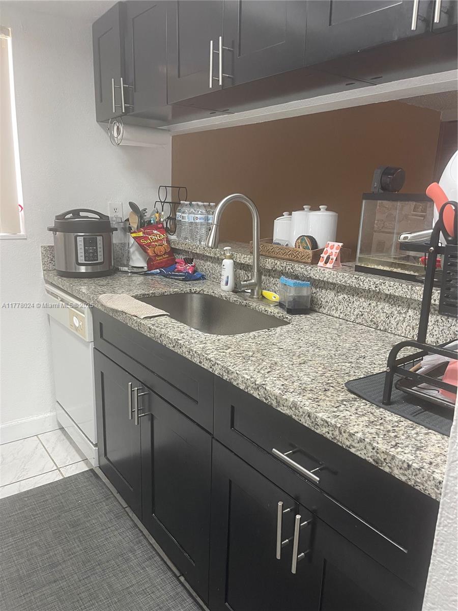 18230 Mediterranean Boulevard, Unit 1302 Hialeah, FL 33015 - Photo 16 of 42 a kitchen with sink and window