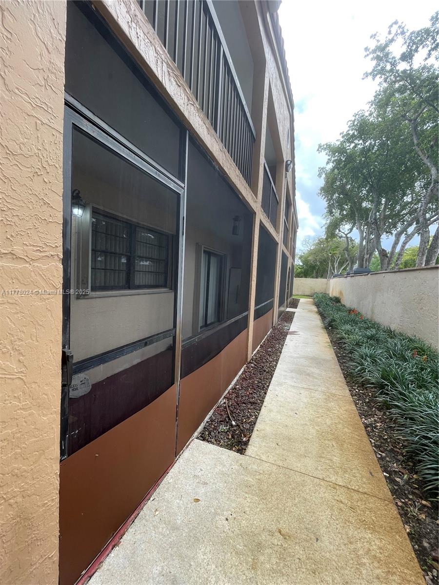 18230 Mediterranean Boulevard, Unit 1302 Hialeah, FL 33015 - Photo 2 of 42 a view of a pathway of a house with a yard