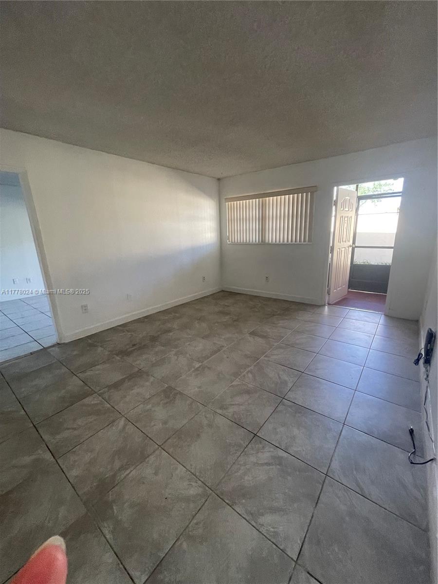 18230 Mediterranean Boulevard, Unit 1302 Hialeah, FL 33015 - Photo 24 of 42 a view of an empty room and window