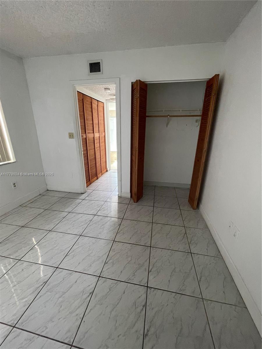 18230 Mediterranean Boulevard, Unit 1302 Hialeah, FL 33015 - Photo 25 of 42 a view of a livingroom with an empty space and a window