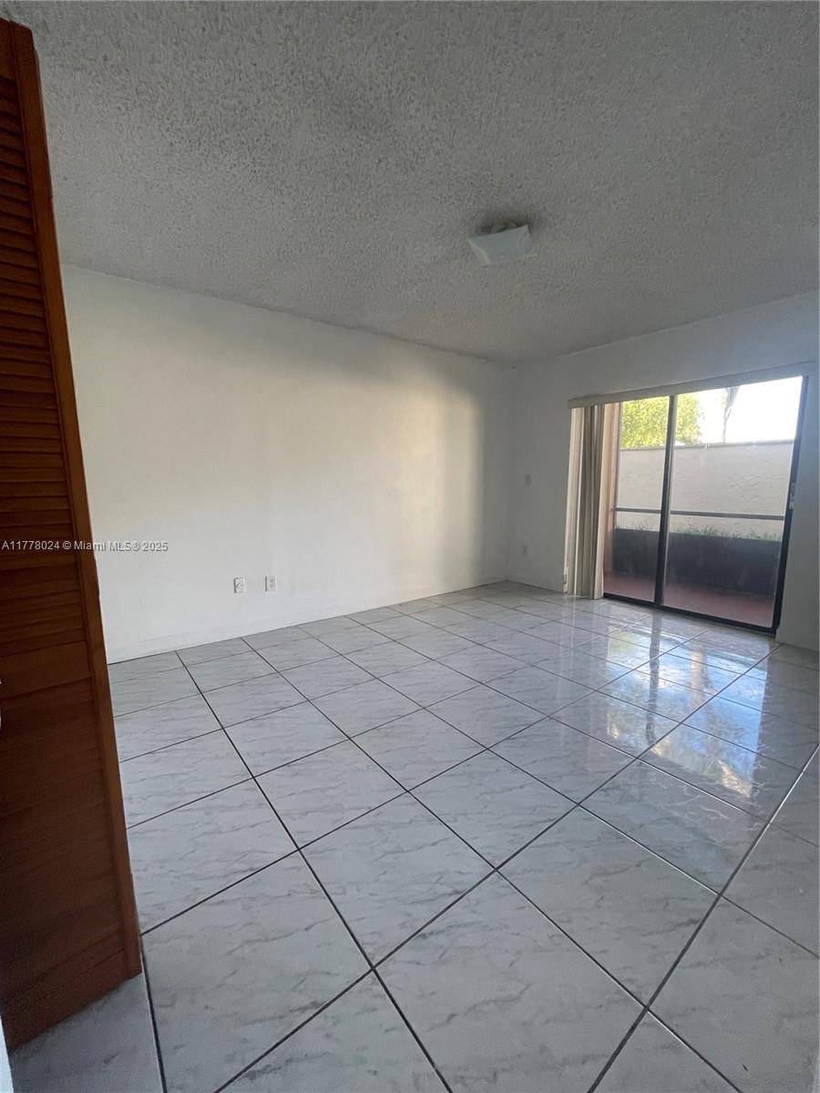 18230 Mediterranean Boulevard, Unit 1302 Hialeah, FL 33015 - Photo 27 of 42 an empty room with windows