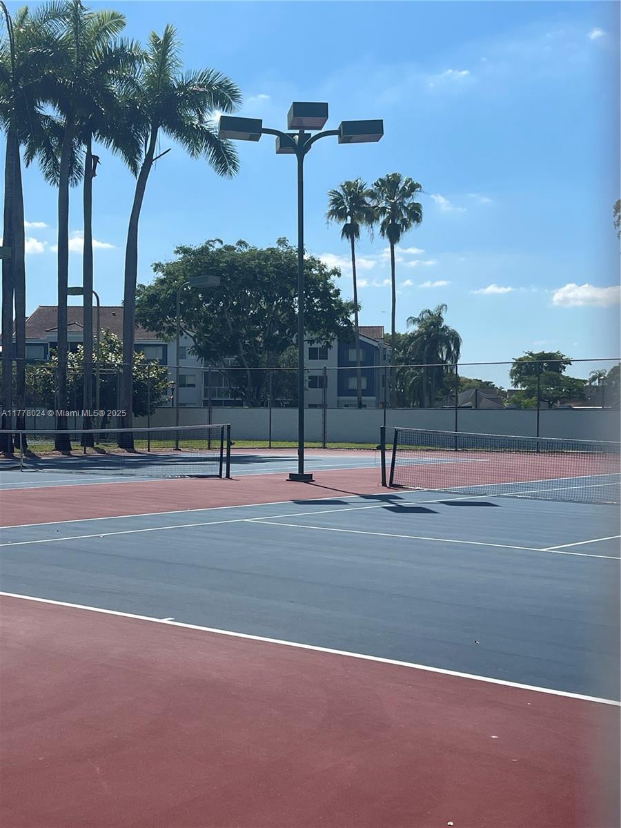 18230 Mediterranean Boulevard, Unit 1302 Hialeah, FL 33015 - Photo 32 of 42 a view of a tennis court