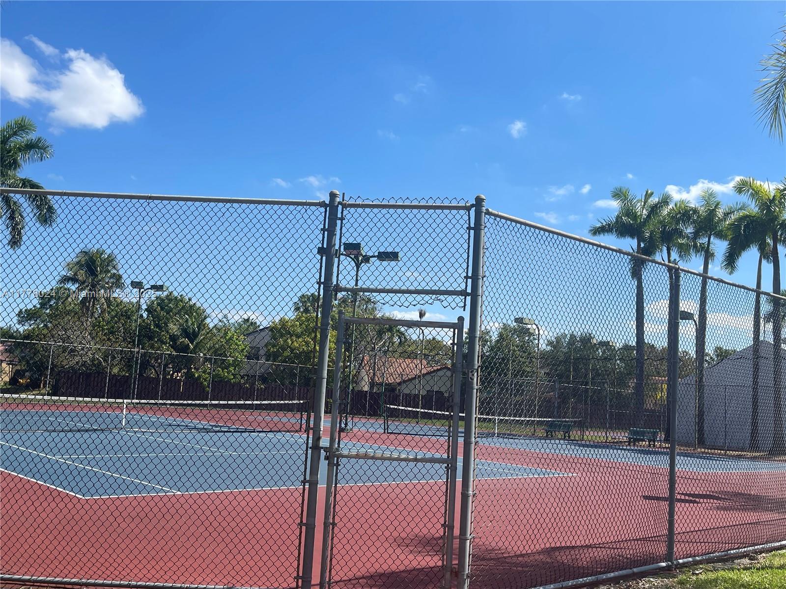 18230 Mediterranean Boulevard, Unit 1302 Hialeah, FL 33015 - Photo 35 of 42 a view of a tennis court