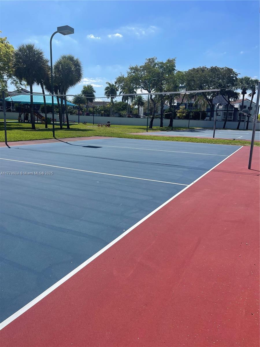 18230 Mediterranean Boulevard, Unit 1302 Hialeah, FL 33015 - Photo 38 of 42 a view of an outdoor space and tennis court