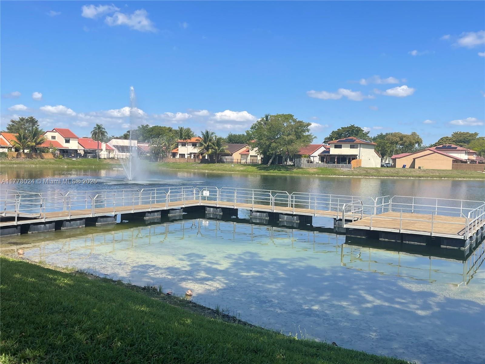 18230 Mediterranean Boulevard, Unit 1302 Hialeah, FL 33015 - Photo 39 of 42 a view of a lake with houses