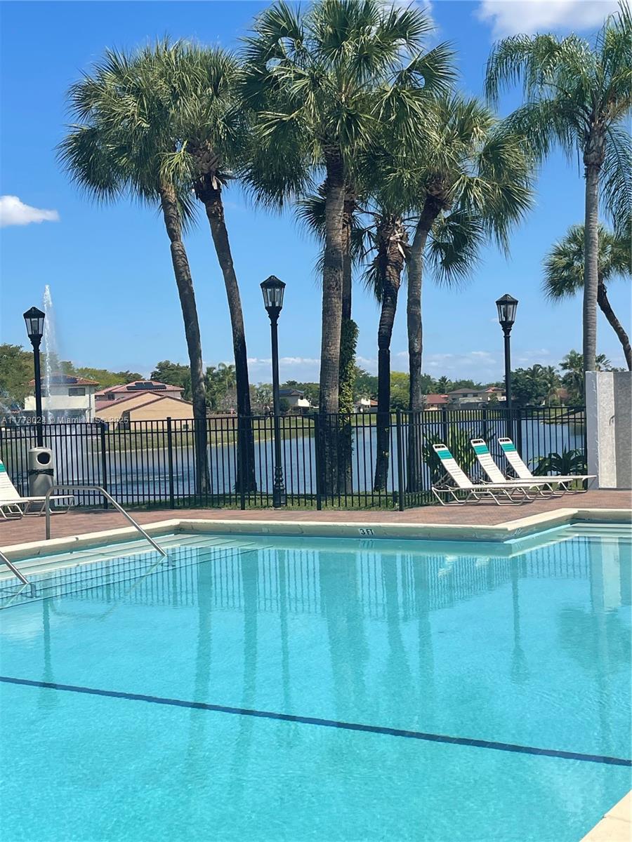 18230 Mediterranean Boulevard, Unit 1302 Hialeah, FL 33015 - Photo 40 of 42 a view of a balcony and floor to ceiling window and palm tree
