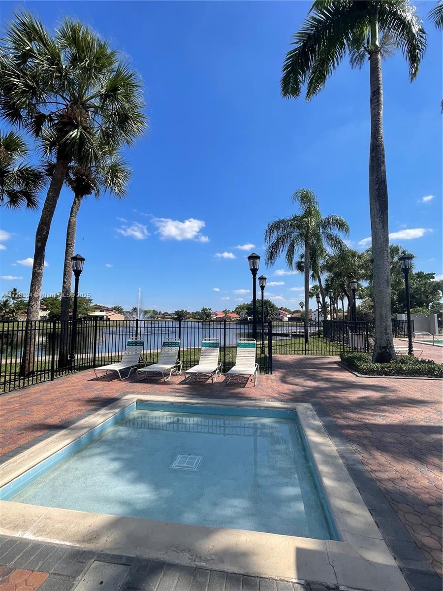 18230 Mediterranean Boulevard, Unit 1302 Hialeah, FL 33015 - Photo 42 of 42 a view of a swimming pool with a yard