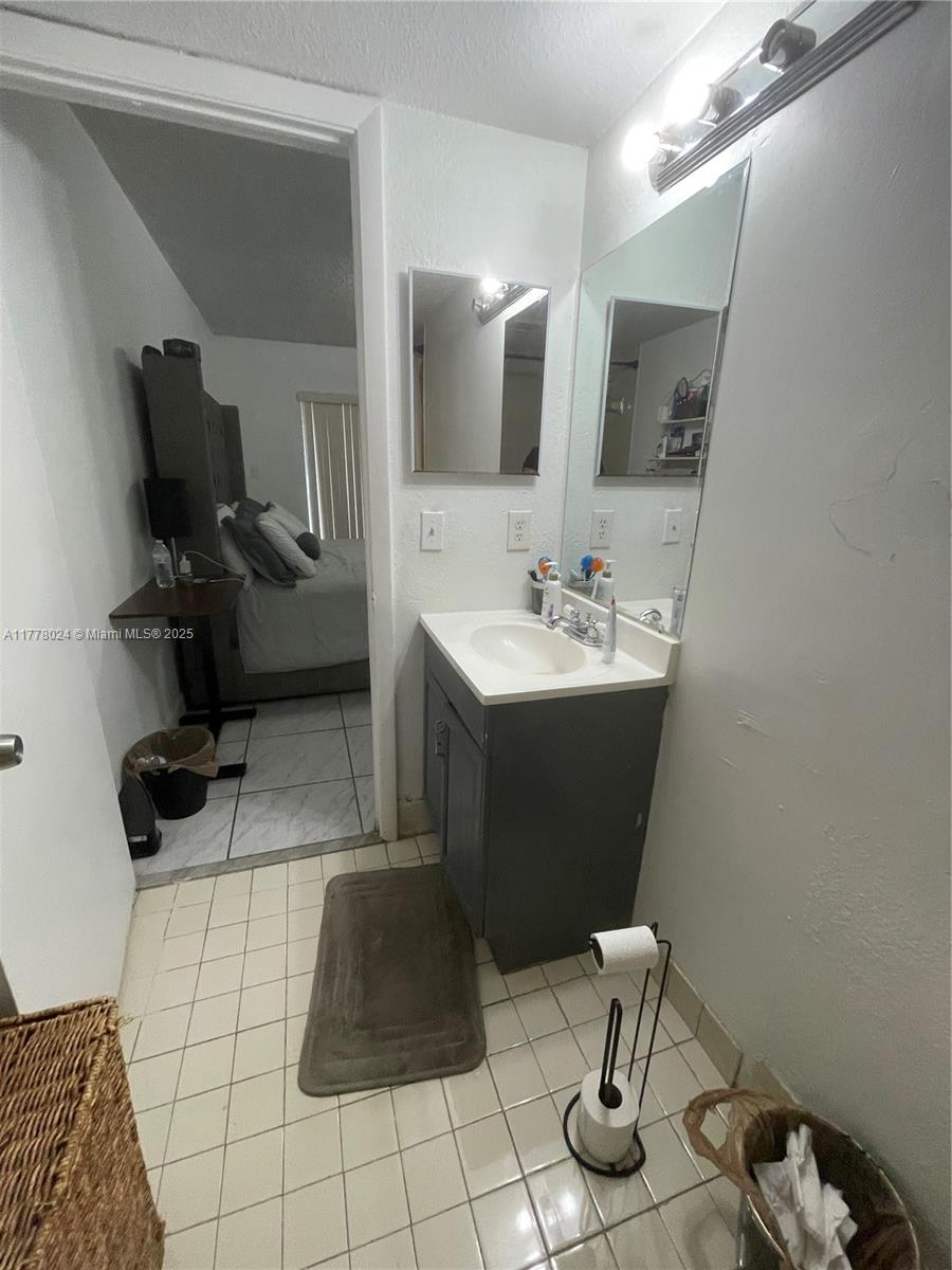 18230 Mediterranean Boulevard, Unit 1302 Hialeah, FL 33015 - Photo 6 of 42 a bathroom with a sink toilet and mirror