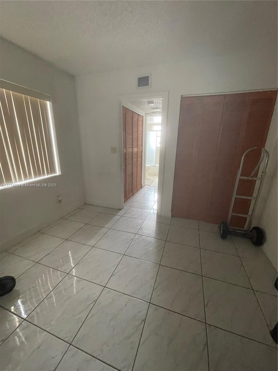 18230 Mediterranean Boulevard, Unit 1302 Hialeah, FL 33015 - Photo 8 of 42 a view of an empty room with a window