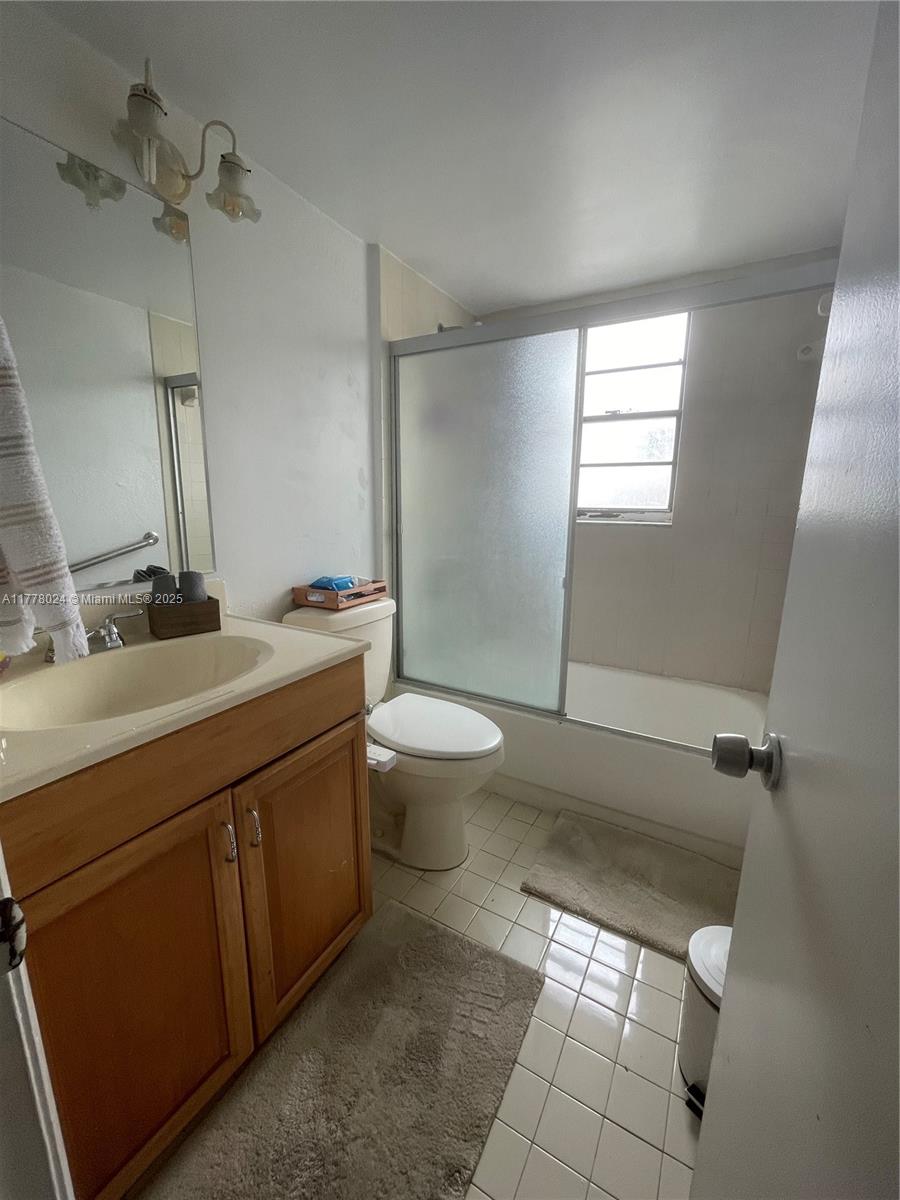 18230 Mediterranean Boulevard, Unit 1302 Hialeah, FL 33015 - Photo 9 of 42 a bathroom with a sink toilet and shower