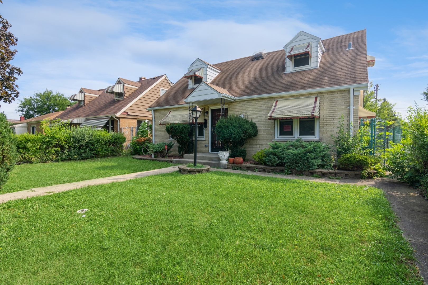 16155 Honore Avenue Markham, IL 60428 - Photo 1 of 10 a front view of house with yard and green space