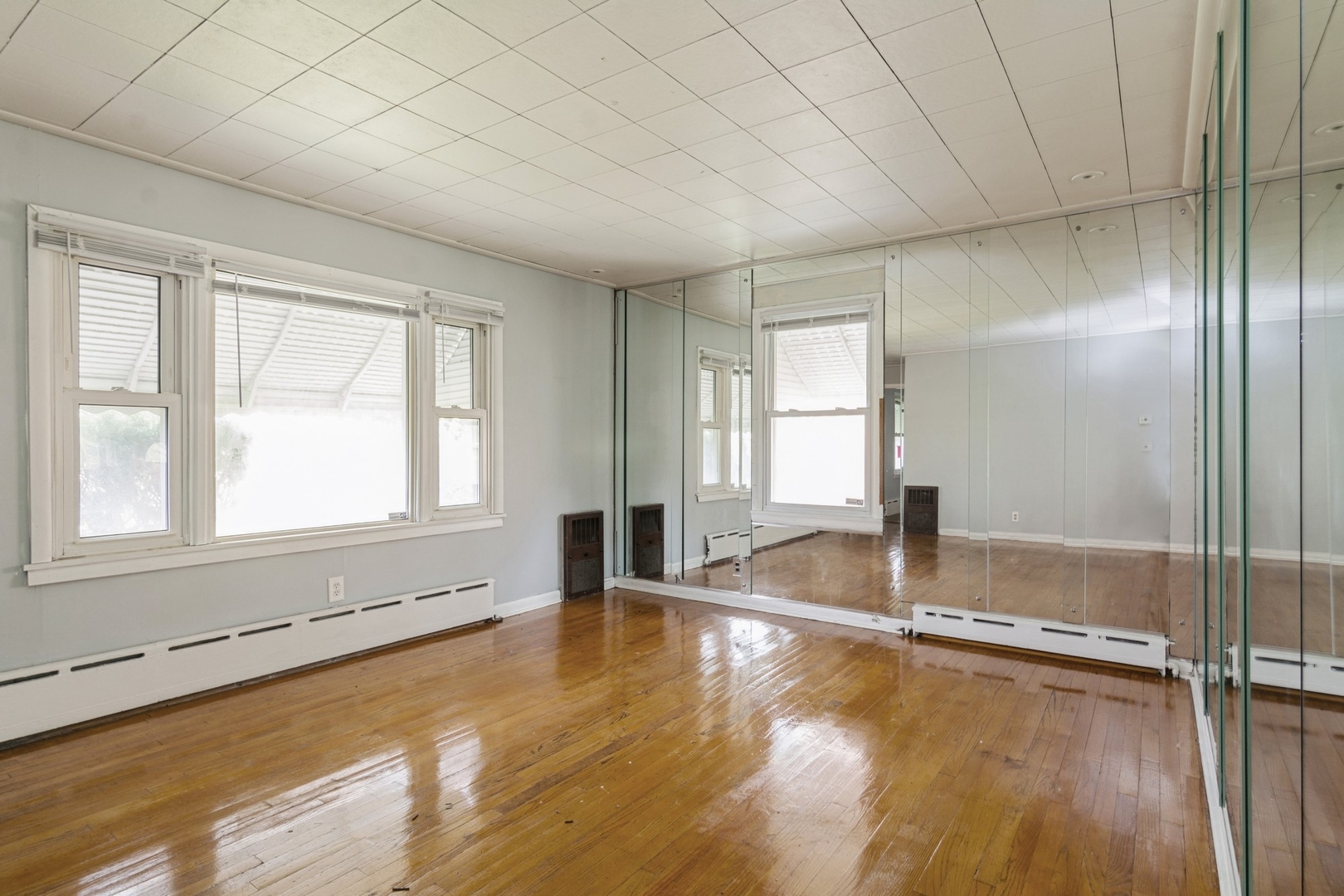 16155 Honore Avenue Markham, IL 60428 - Photo 2 of 10 an empty room with wooden floor and window