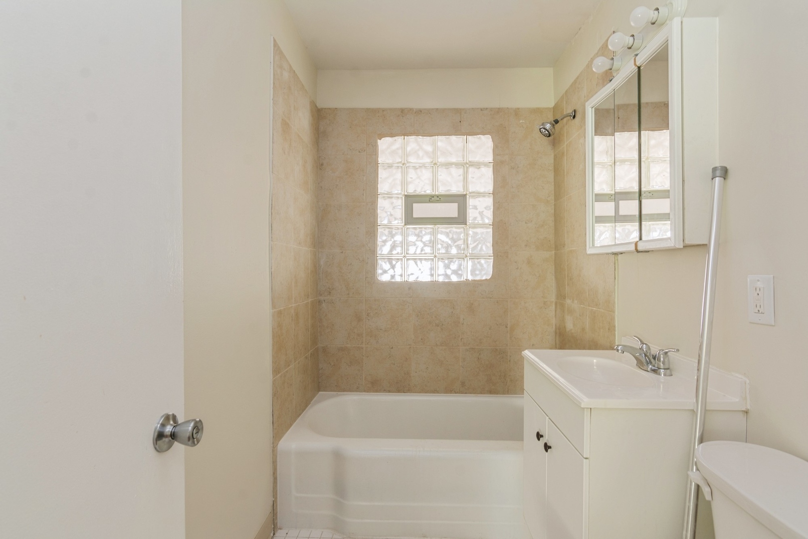 16155 Honore Avenue Markham, IL 60428 - Photo 6 of 10 a bathroom with a bathtub sink and window