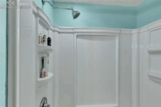 a bathroom with a shower and a mirror