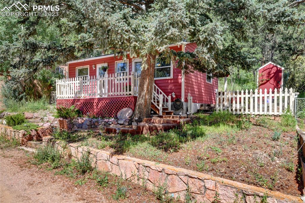 8236 Highway 24 Cascade, CO 80809 - Photo 2 of 24 a view of a house with a yard and wooden fence