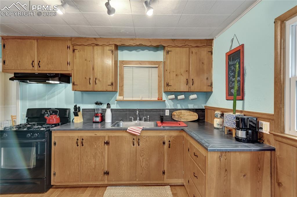8236 Highway 24 Cascade, CO 80809 - Photo 7 of 24 a kitchen with stainless steel appliances granite countertop a sink stove and cabinets