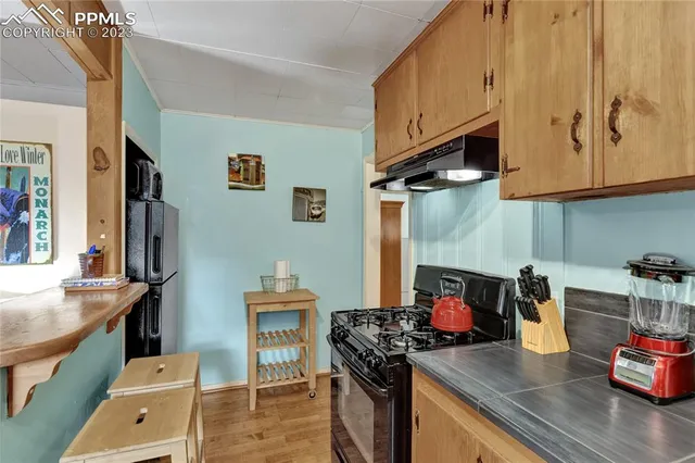a kitchen with stainless steel appliances granite countertop a stove and a refrigerator